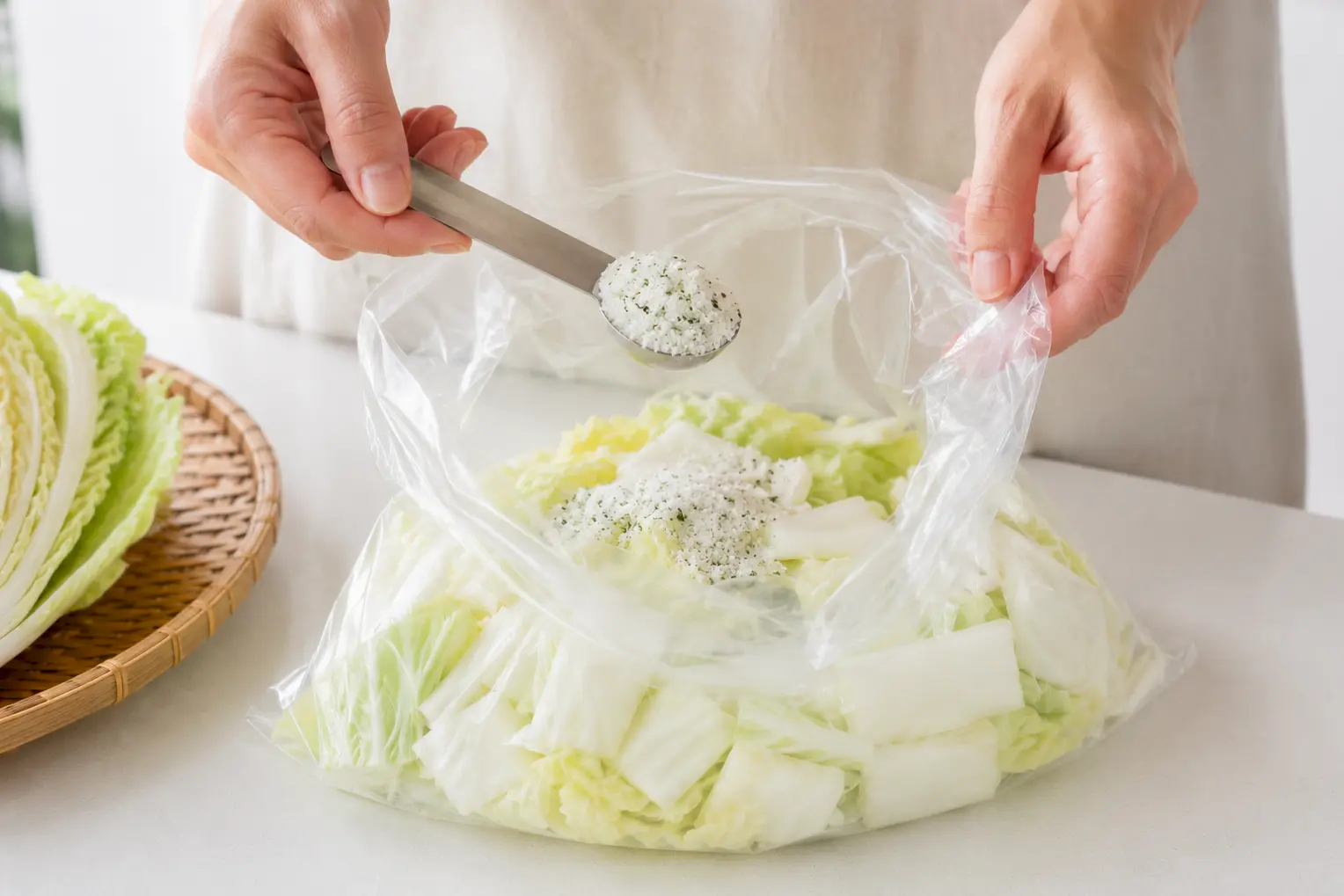 白菜の入った袋にあさ漬の素を加える工程