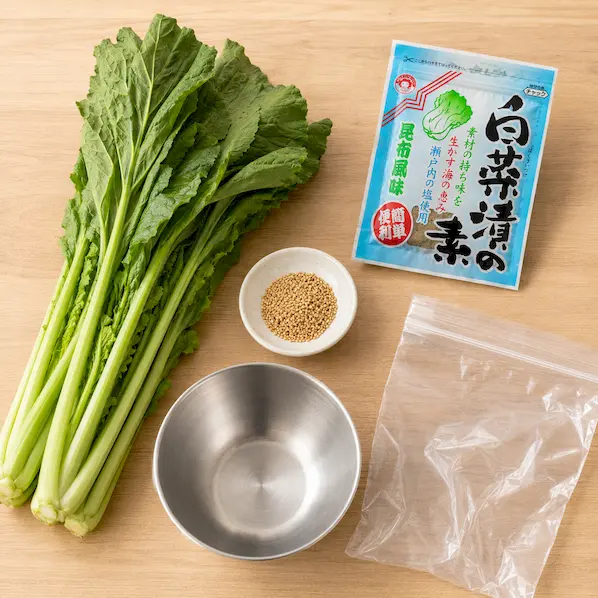 野沢菜、白菜漬の素、いりごま、ポリ袋、ボウルを用意したイメージ